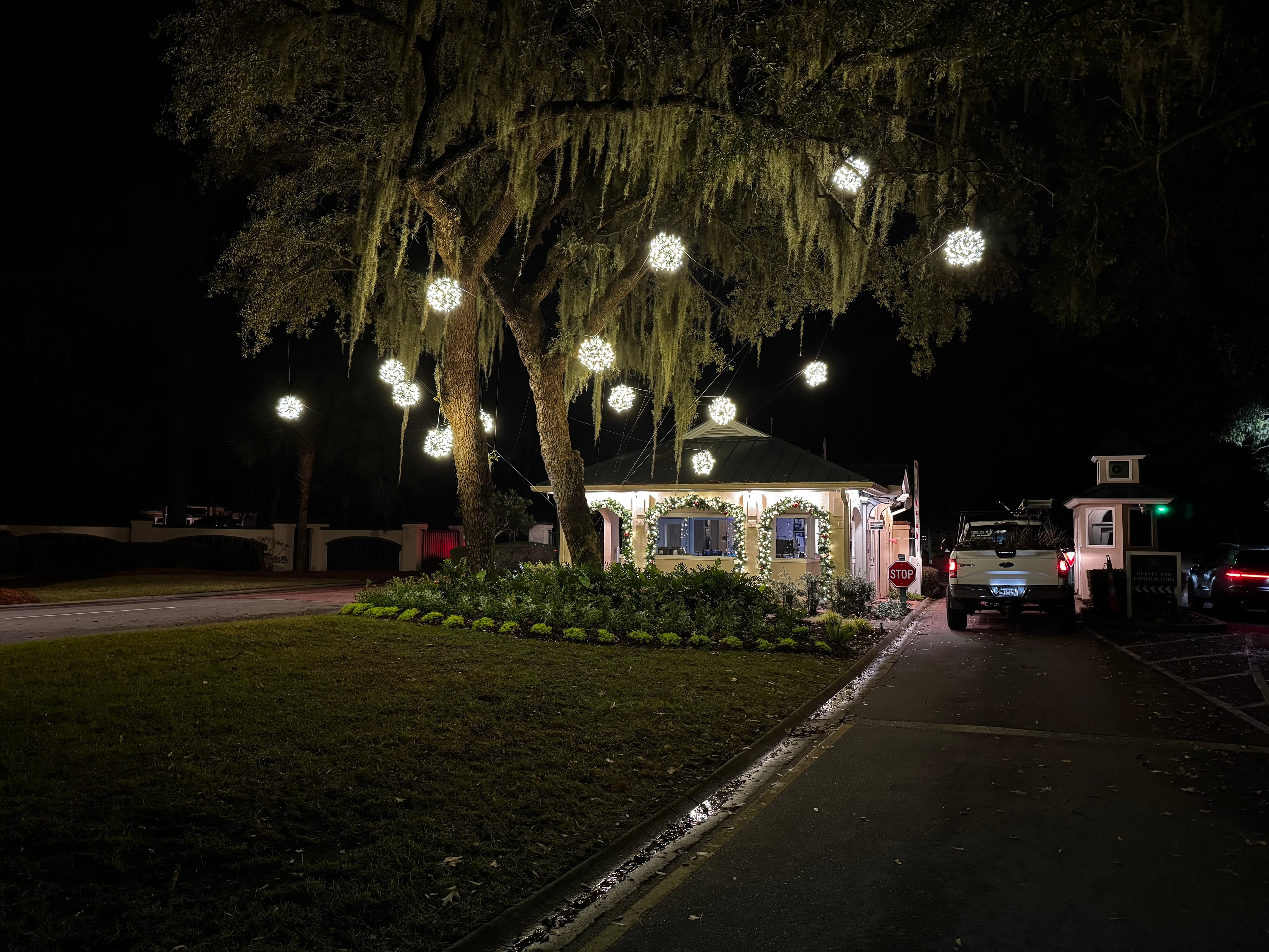 Indigo Run gatehouse with light ball display hanging from a grand live oak